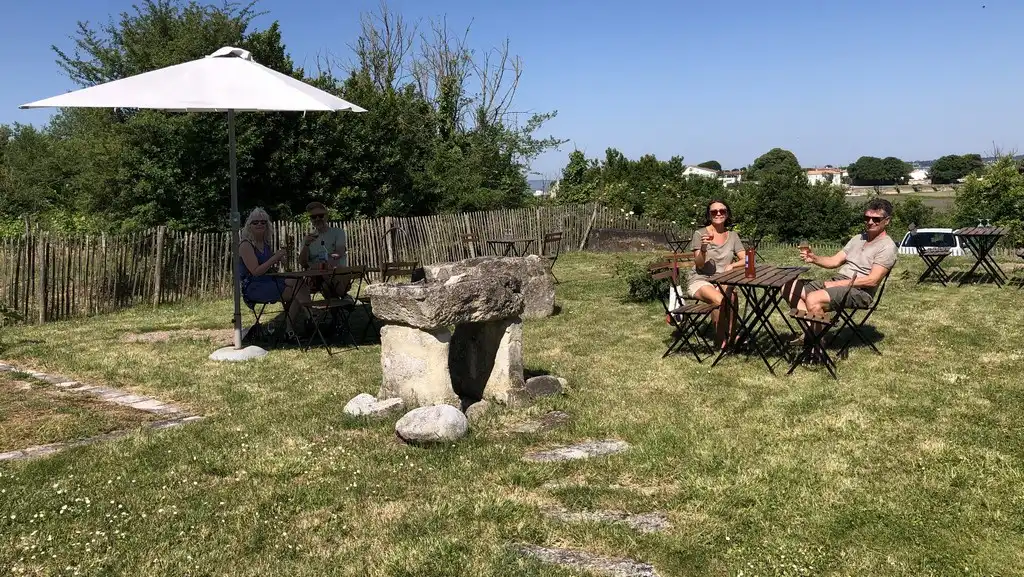 Au Vignoble Les Hauts de Talmont les visiteurs profitent d'une dégustation de nos vins dans notre jardin